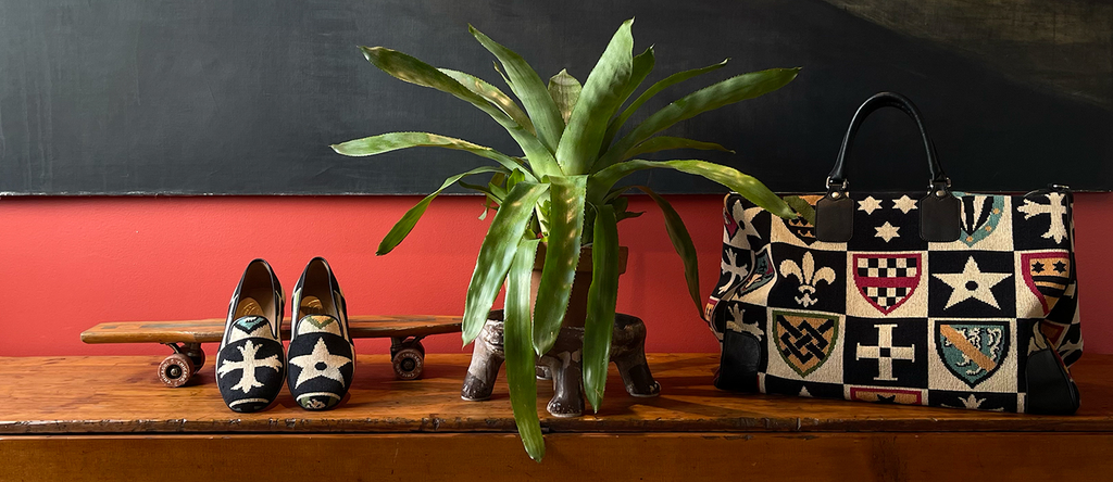 Crest slipper propped on skateboard with plant and weekender bag