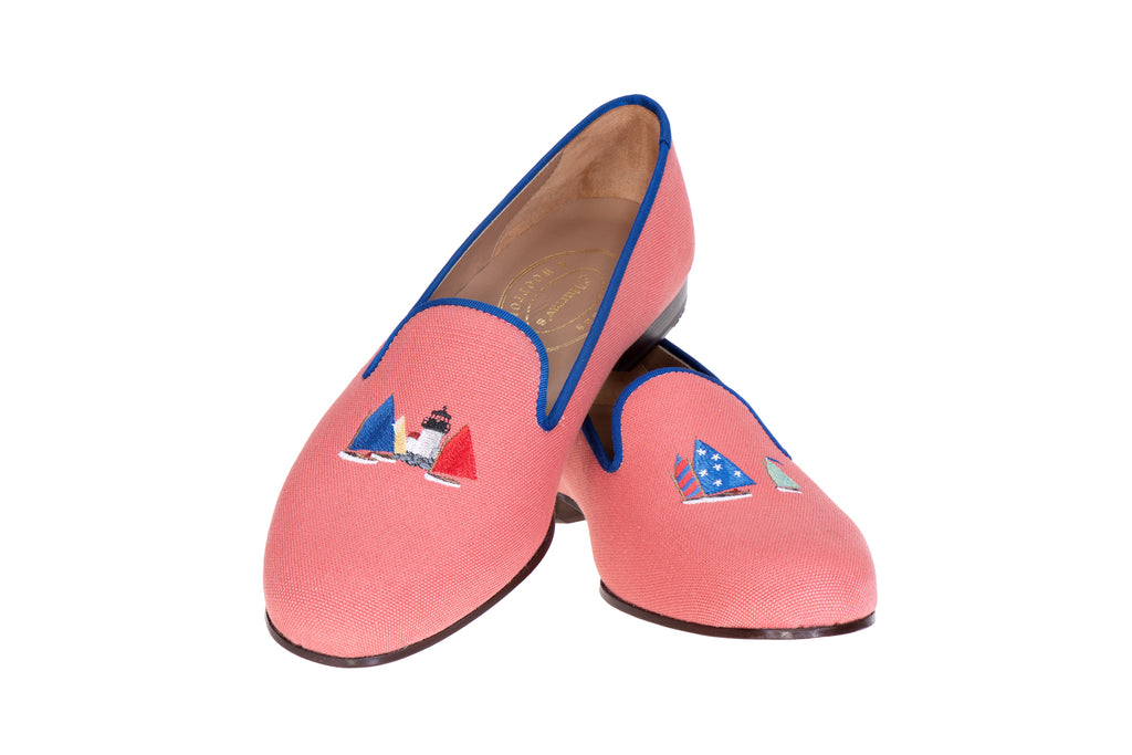 Red slipper with sailboats on white background.