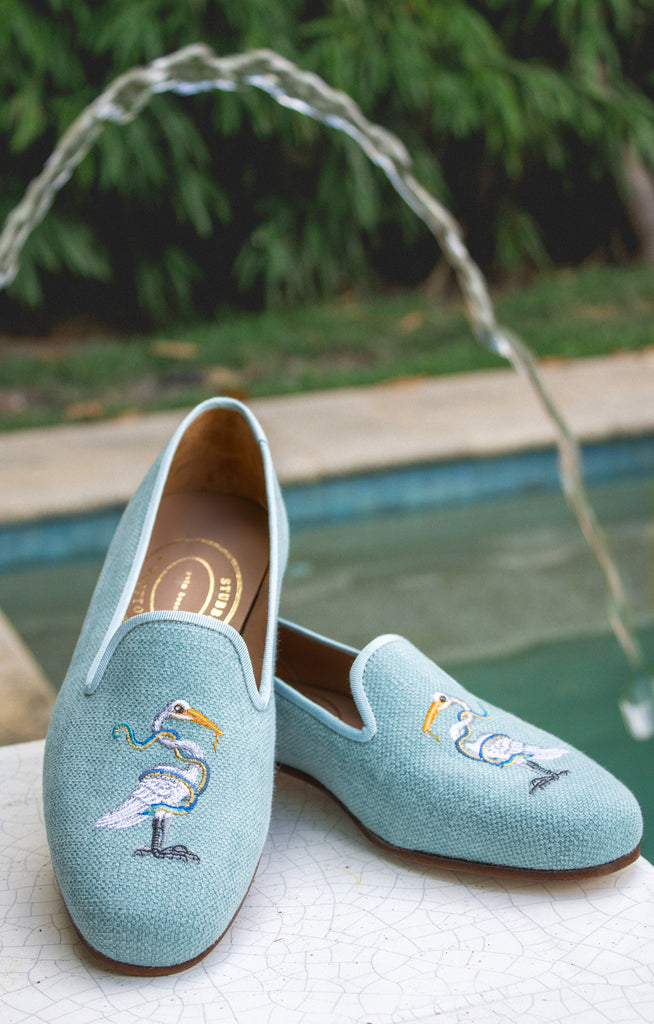 A photograph of the Heron Sky Linen Slipper in Palm Beach.