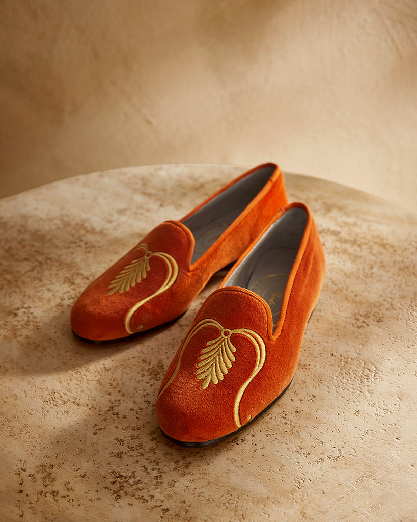 Orange slippers on a stone table