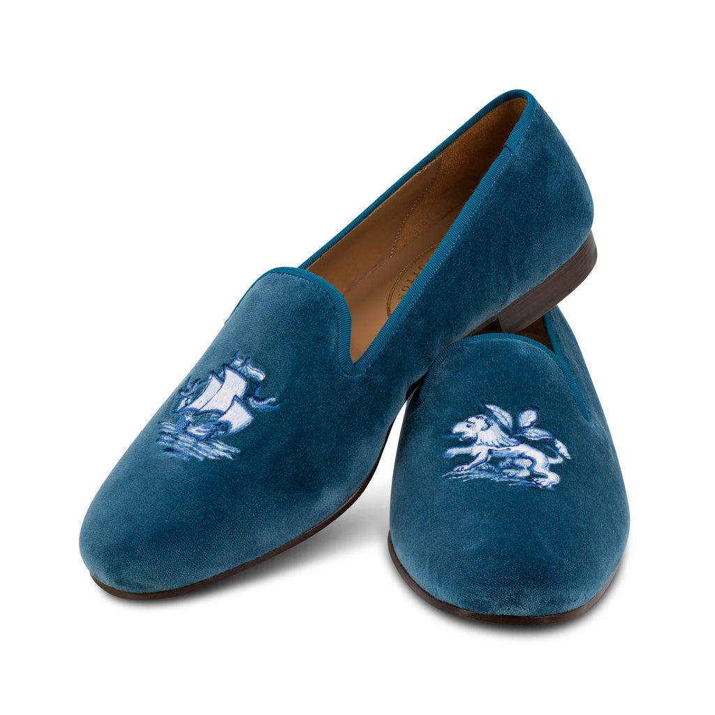 Our blue delft slipper on a white background.