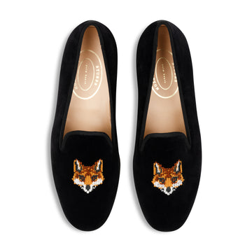 Black loafers with fox embroidery on a white background