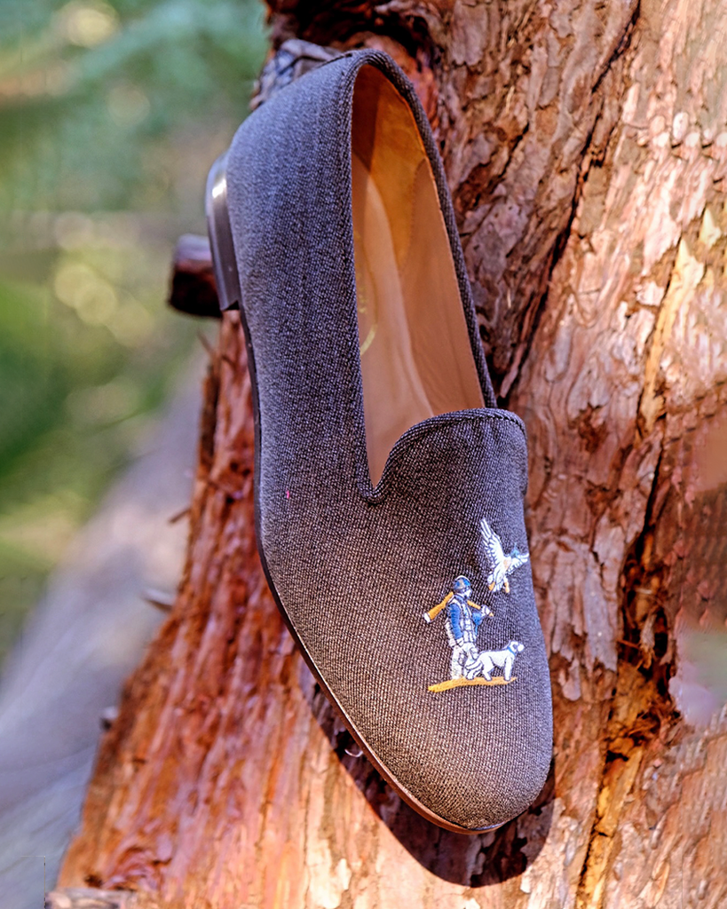Fowl Twill slippers placed on a tree