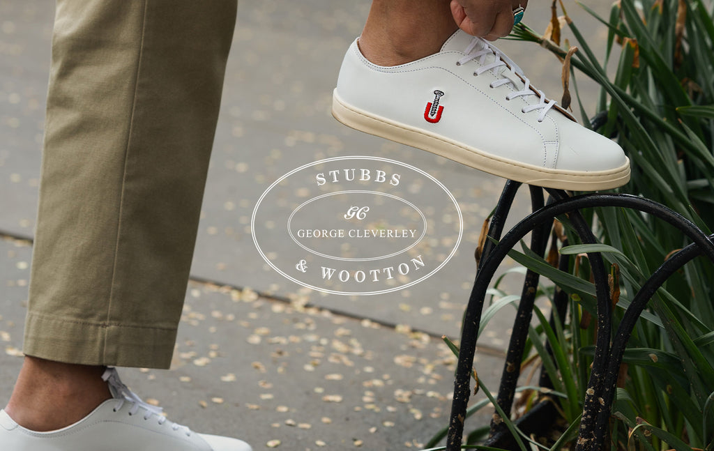 Image of white sneakers with embroidery being worn.