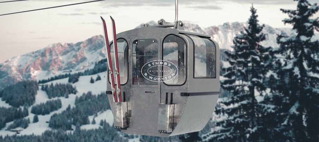 A ski gondola with snow-covered mountains in the background
